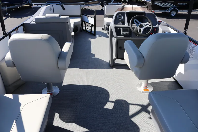 Slide: The Image of Interior of 2025 SunChaser Lucerne 20 LR DH pontoon boat with gray seating and steering console. - 7