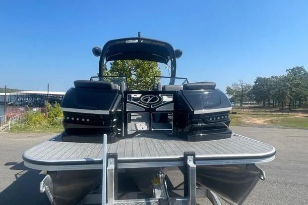 Slide: The Image of 2023 Veranda V One 25 pontoon boat on a sunny day, docked on a trailer. - 12
