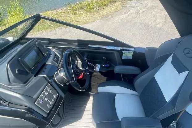 Slide: The Image of 2023 Veranda V One 25 boat cockpit with modern steering and controls. - 2