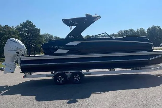 Slide: The Image of 2023 Veranda V One 25 pontoon boat on trailer, parked outdoors. - 8