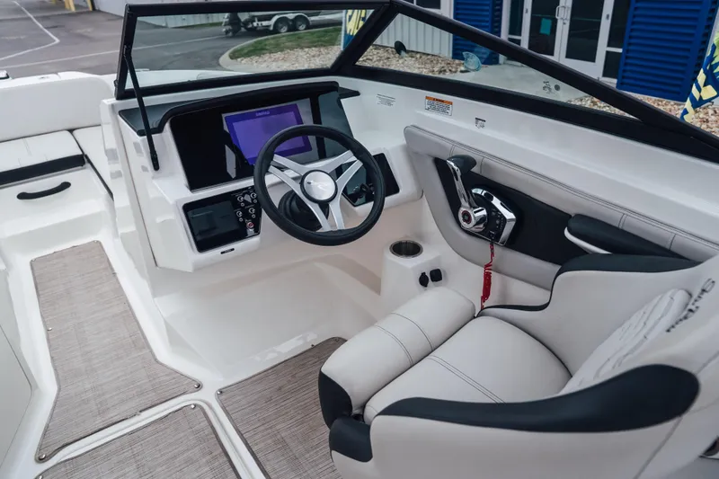 Slide: The Image of 2024 Sea Ray SPX 210 Outboard boat interior with modern dashboard and steering wheel. - 10