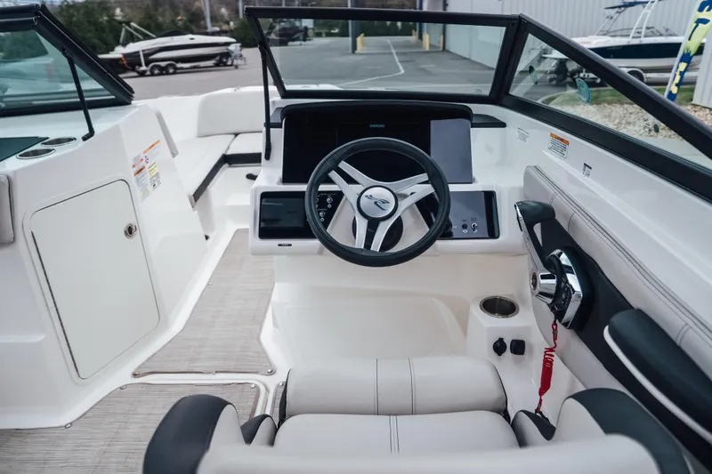 Slide: The Image of 2024 Sea Ray SPX 210 Outboard boat interior with modern steering and dashboard. - 11