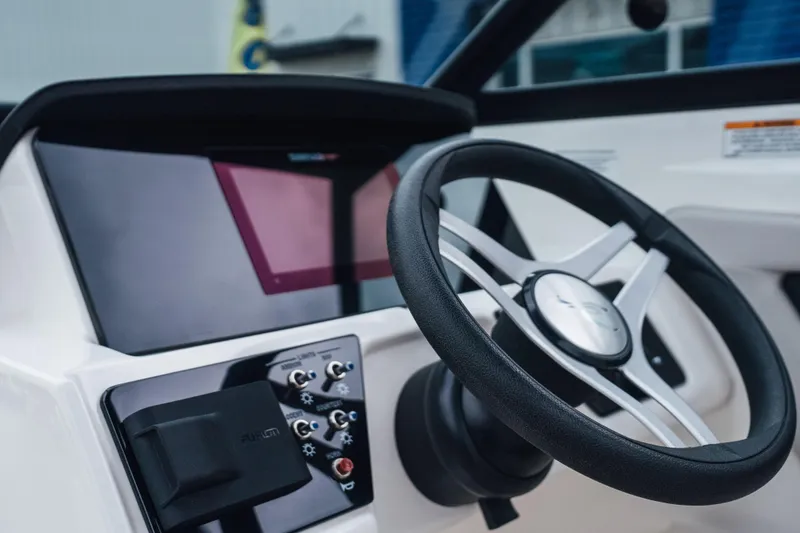 Slide: The Image of 2024 Sea Ray SPX 210 Outboard steering wheel and dashboard close-up. - 13