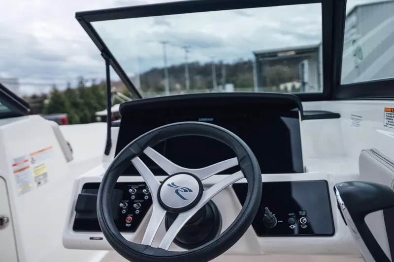 Slide: The Image of 2024 Sea Ray SPX 210 Outboard steering wheel and dashboard view. - 16