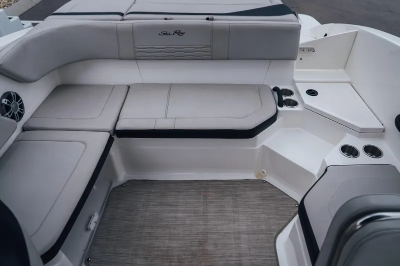 Slide: The Image of 2024 Sea Ray SPX 210 Outboard boat interior with cushioned seating and cup holders. - 17