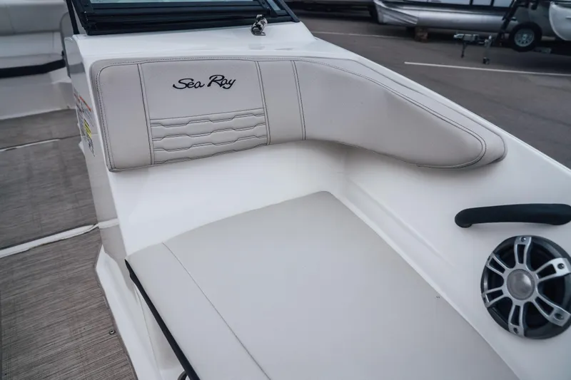 Slide: The Image of 2024 Sea Ray SPX 210 Outboard boat interior with cushioned seating and speaker. - 20