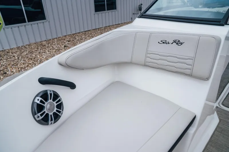 Slide: The Image of 2024 Sea Ray SPX 210 Outboard boat interior with white seating and speaker. - 21