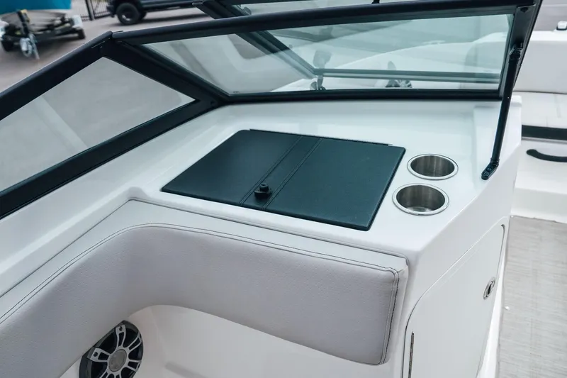 Slide: The Image of 2024 Sea Ray SPX 210 Outboard boat interior with cup holders and storage compartment. - 22