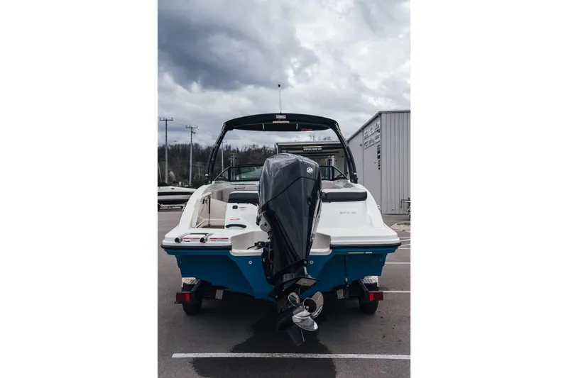Slide: The Image of 2024 Sea Ray SPX 210 Outboard boat, rear view, parked outdoors under cloudy sky. - 3