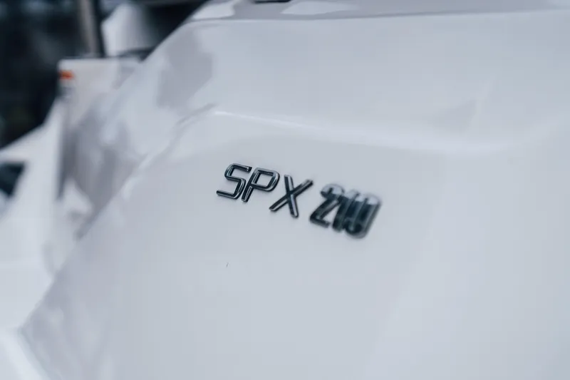 Slide: The Image of 2024 Sea Ray SPX 210 Outboard logo on sleek white surface. - 4