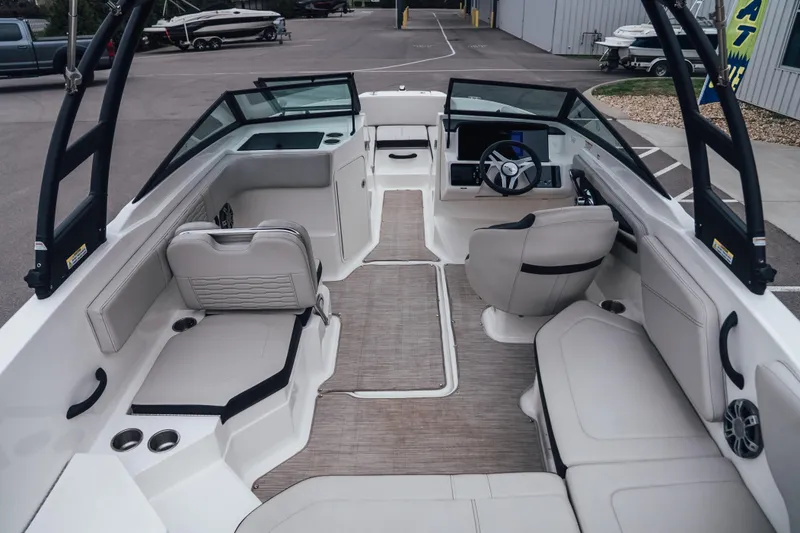 Slide: The Image of 2024 Sea Ray SPX 210 Outboard boat interior with modern seating and steering console. - 8
