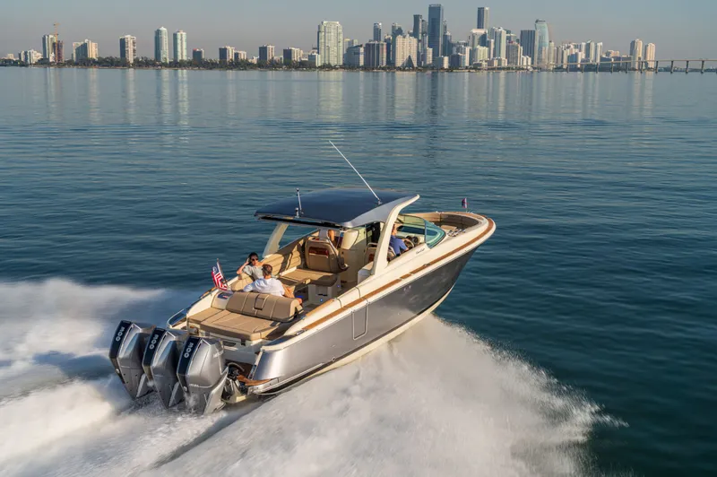 The Image of 2026 Chris-Craft Launch 35 GT cruising on water with city skyline. - 0