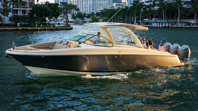 Slide: The Image of 2026 Chris-Craft Launch 35 GT cruising on water at sunset. - 2