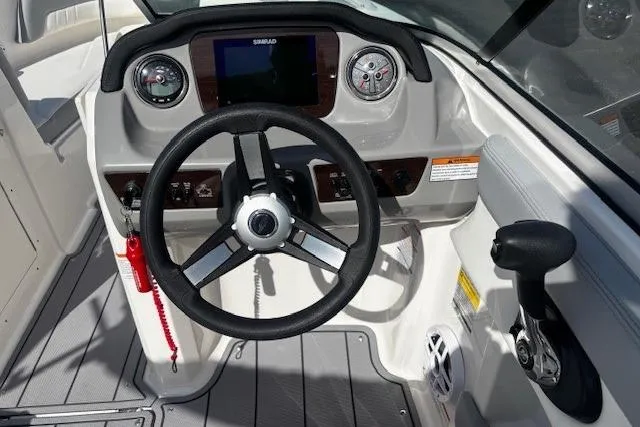 Slide: The Image of 2023 Chaparral 21 SSi boat dashboard with steering wheel and control panel. - 20