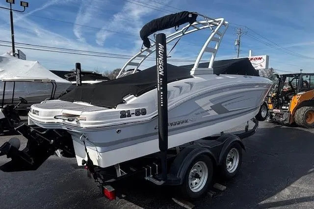 Slide: The Image of 2023 Chaparral 21 SSi boat on trailer, covered and parked outdoors. - 21