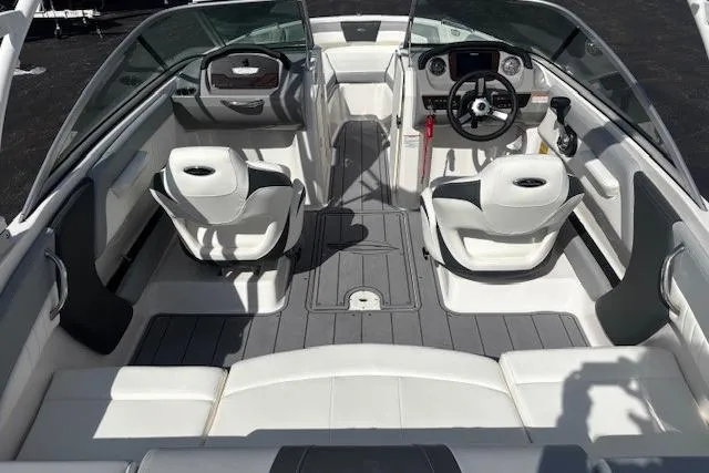 Slide: The Image of 2023 Chaparral 21 SSi boat interior with white seating and modern dashboard. - 25