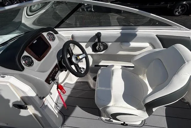 Slide: The Image of 2023 Chaparral 21 SSi boat interior with steering wheel and captain's seat. - 26