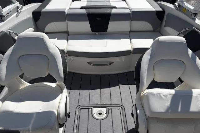 Slide: The Image of 2023 Chaparral 21 SSi boat interior with white seating and gray flooring. - 27