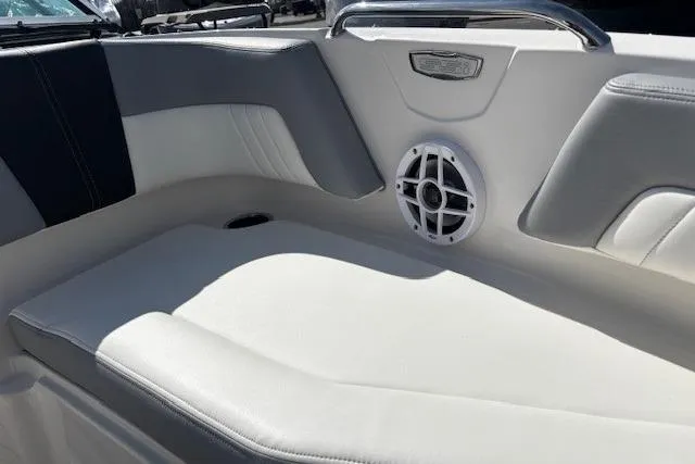 Slide: The Image of 2023 Chaparral 21 SSi boat interior with white seating and speaker detail. - 29