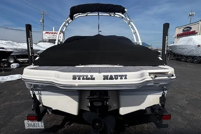 Slide: The Image of 2023 Chaparral 21 SSi boat with cover, rear view, parked outdoors. - 37