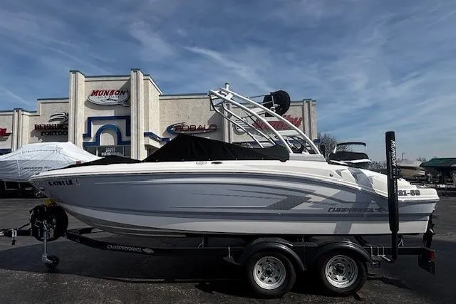 Slide: The Image of 2023 Chaparral 21 SSi boat on trailer, parked outside dealership under clear sky. - 40