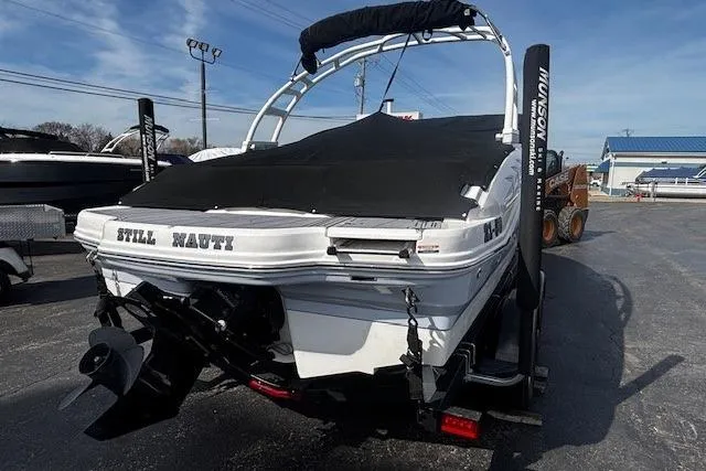 Slide: The Image of 2023 Chaparral 21 SSi boat with cover, parked on trailer in outdoor lot. - 42
