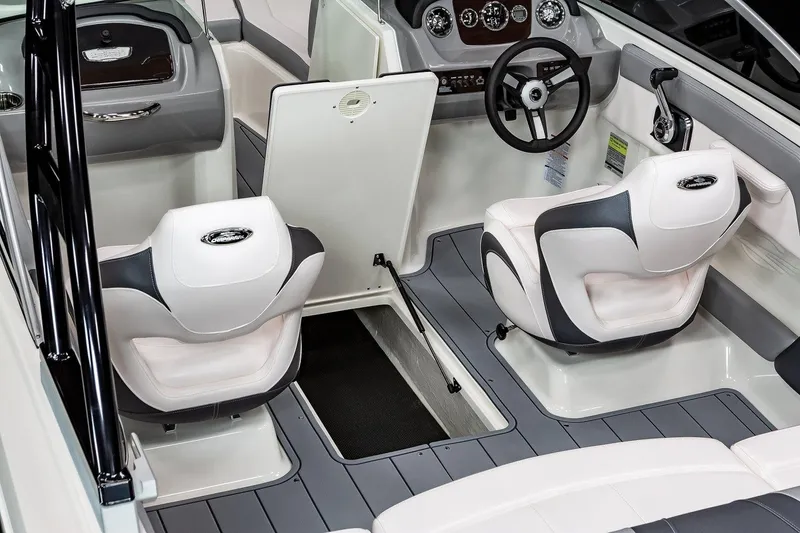 Slide: The Image of Manufacturer Provided Image: 2023 Chaparral 21 SSi boat interior with white and gray seating, steering wheel, and storage. - 8