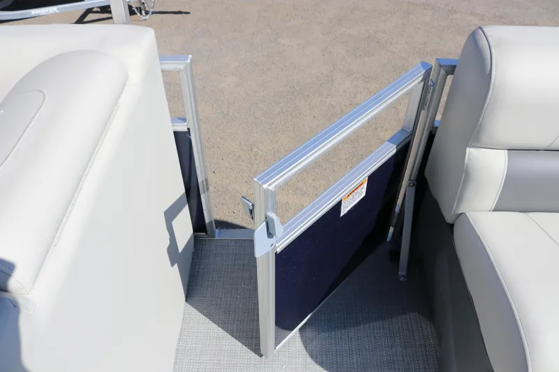 Slide: The Image of 2025 SunChaser Vista 18 LR boat interior with open gate and cushioned seating. - 11