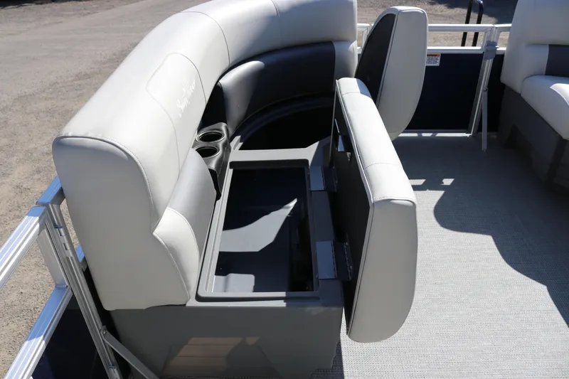 Slide: The Image of 2025 SunChaser Vista 18 LR pontoon boat with open storage compartment and cup holders. - 12