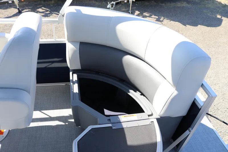 Slide: The Image of SunChaser Vista 18 LR 2025 boat interior with curved seating and storage compartment. - 17