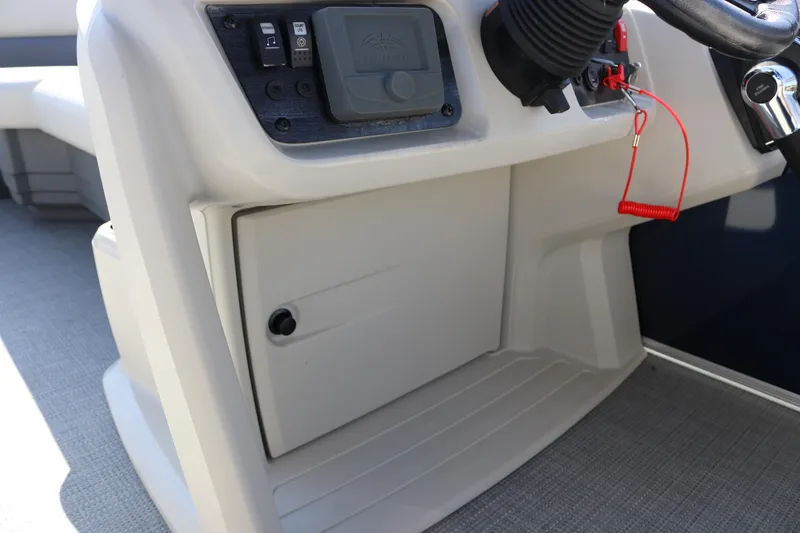 Slide: The Image of Control panel of 2025 SunChaser Vista 18 LR boat, featuring steering and switches. - 19