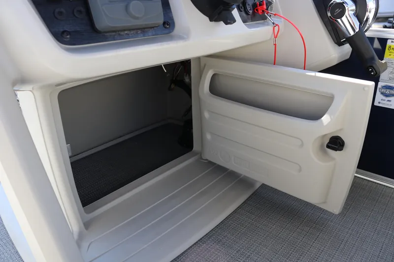 Slide: The Image of Open storage compartment in 2025 SunChaser Vista 18 LR boat console. - 20
