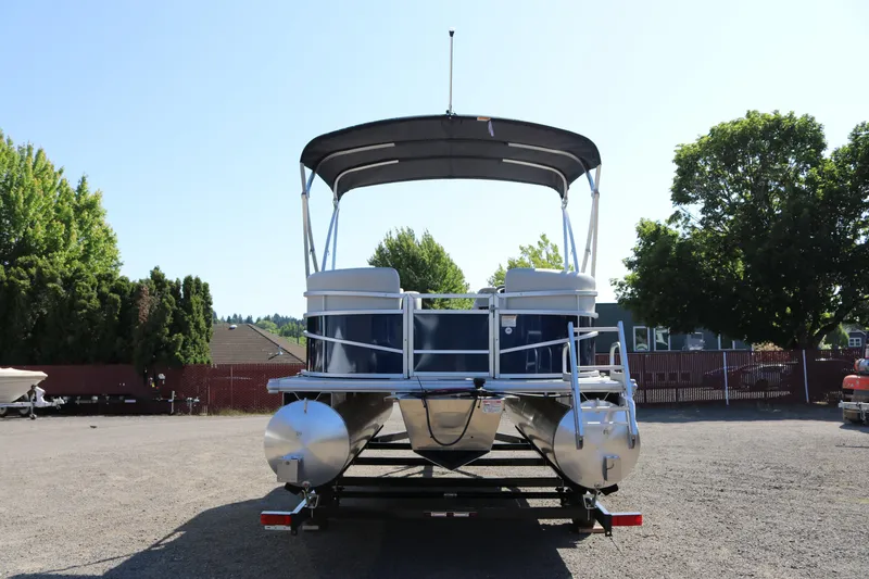 The Image of 2025 SunChaser Vista 18 LR pontoon boat on trailer, parked outdoors. - 3