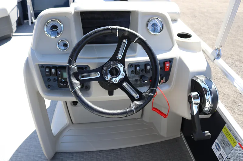 Slide: The Image of 2025 SunChaser Vista 18 LR boat dashboard with steering wheel and controls. - 7
