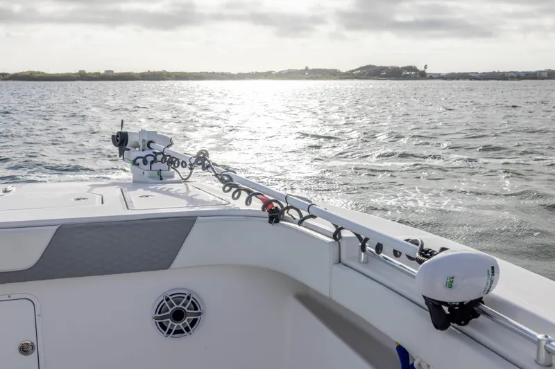 Slide: The Image of 2024 Invincible 35 Catamaran on water, showcasing deck and fishing rod holders. - 10