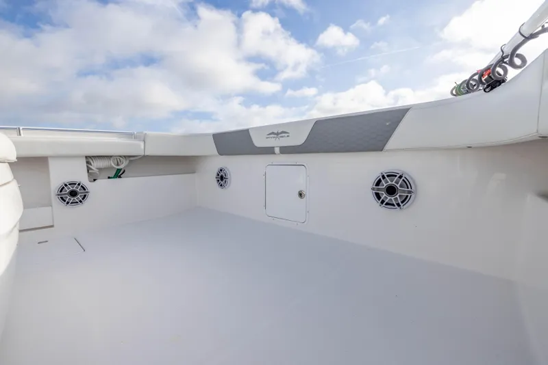 Slide: The Image of 2024 Invincible 35 Catamaran deck with speakers and storage, under a cloudy sky. - 12