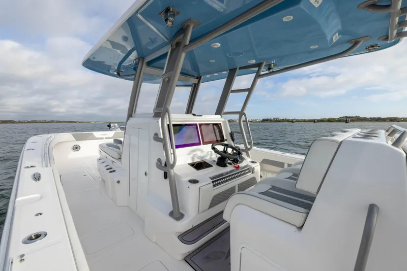 Slide: The Image of 2024 Invincible 35 Catamaran interior with modern helm and seating on open water. - 20
