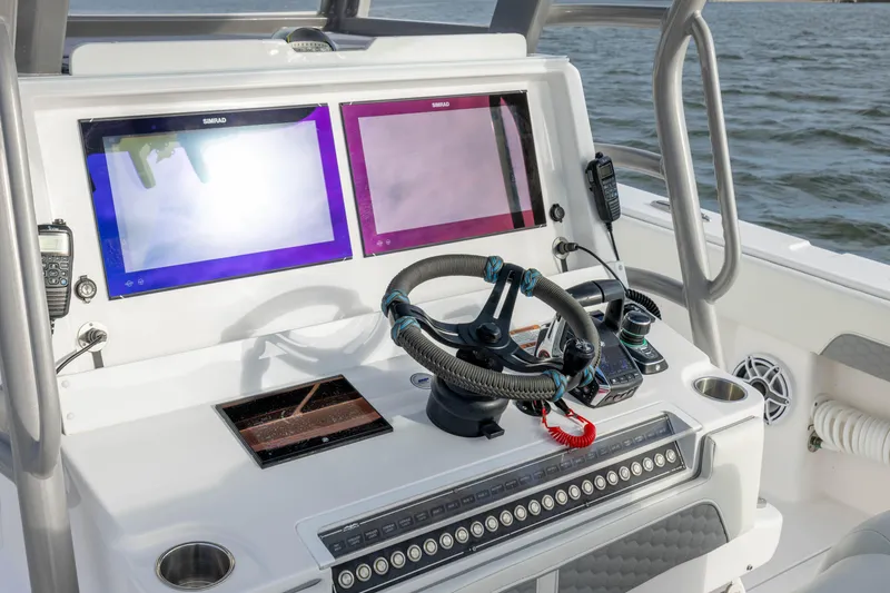 Slide: The Image of 2024 Invincible 35 Catamaran helm with dual Simrad displays and modern controls. - 23