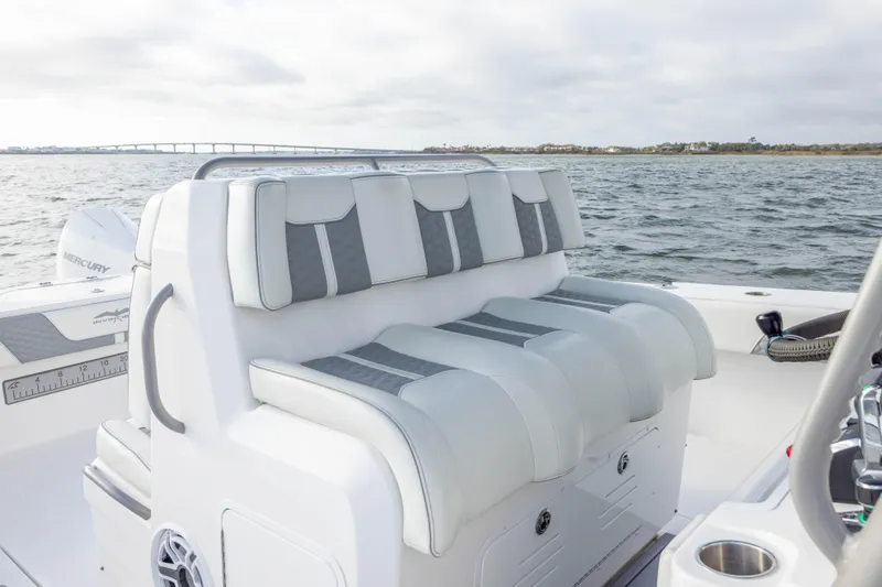 Slide: The Image of 2024 Invincible 35 Catamaran with luxurious seating, on open water with bridge in background. - 26