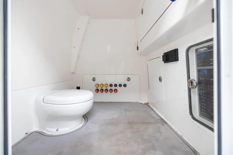 Slide: The Image of 2024 Invincible 35 Catamaran interior with toilet and control panel. - 37