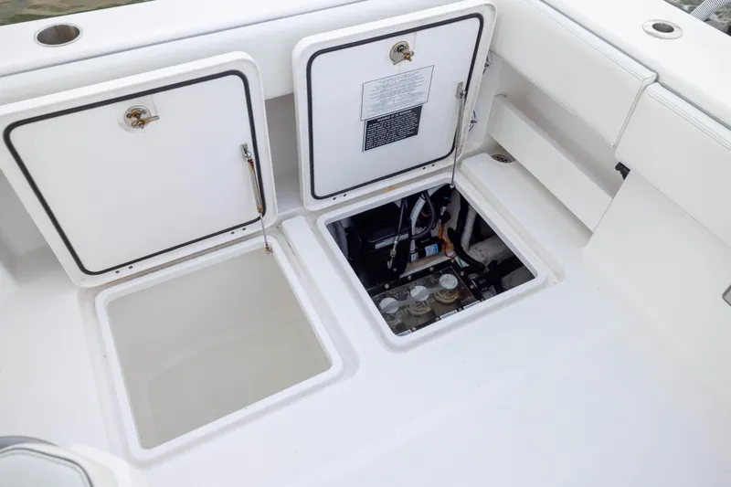 Slide: The Image of 2024 Invincible 35 Catamaran deck with open storage compartments and visible wiring. - 38