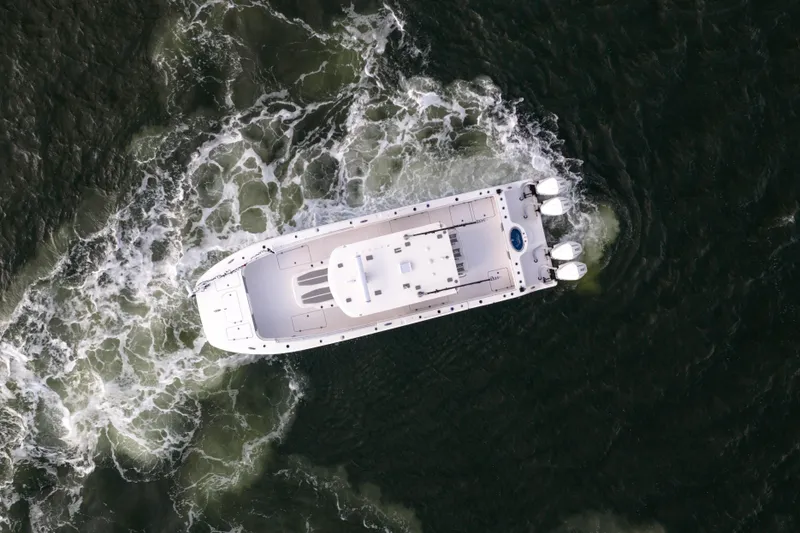 Slide: The Image of Aerial view of 2024 Invincible 35 Catamaran navigating through ocean waves. - 4