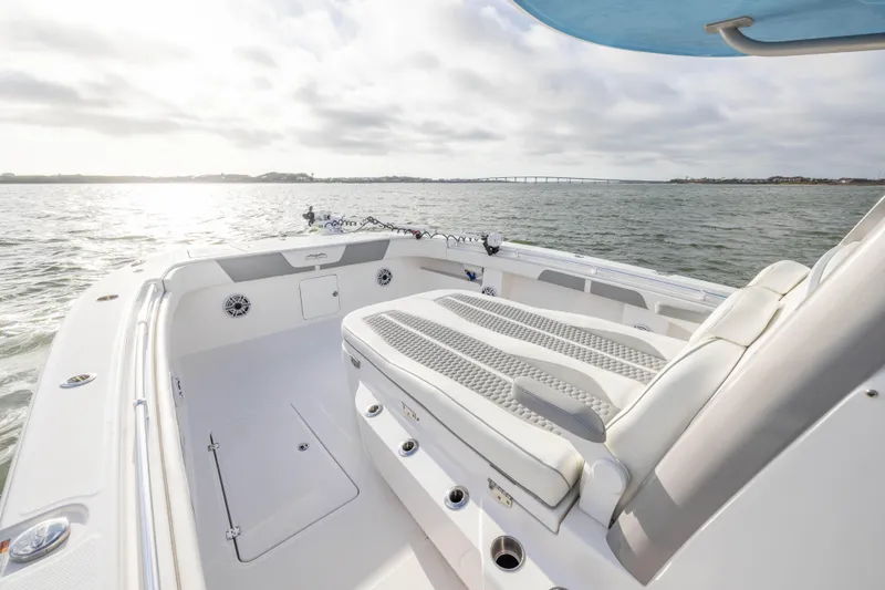 Slide: The Image of 2024 Invincible 35 Catamaran interior with cushioned seating, on open water. - 7