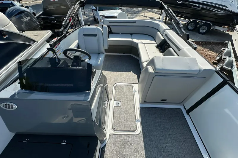 Slide: The Image of 2026 Hurricane FunDeck 1960 REF OB boat interior with seating and steering console. - 13