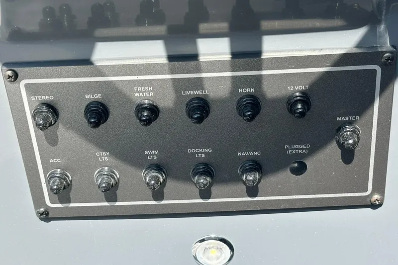 Slide: The Image of Control panel of 2026 Hurricane FunDeck 1960 REF OB boat with various switches. - 18