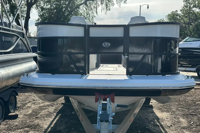 Slide: The Image of 2026 Hurricane FunDeck 1960 REF OB boat on trailer, parked outdoors. - 2