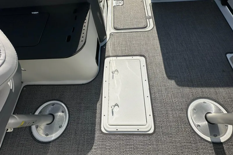 Slide: The Image of 2026 Hurricane FunDeck 1960 REF OB boat interior with carpeted flooring and seat bases. - 24