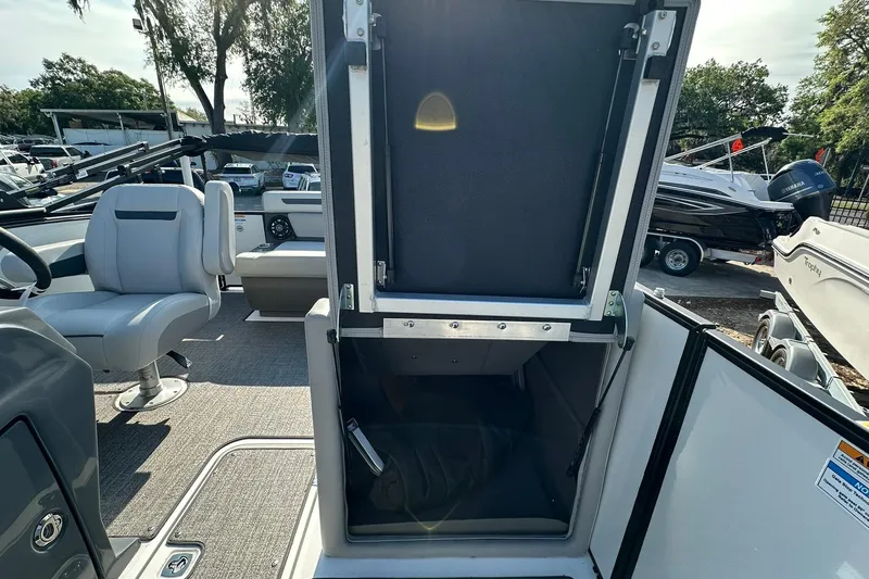 Slide: The Image of 2026 Hurricane FunDeck 1960 REF OB boat interior with open storage compartment and seating. - 30