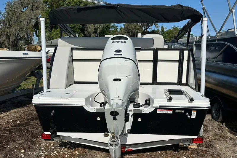 Slide: The Image of 2026 Hurricane FunDeck 1960 REF OB boat with powerful outboard motor, docked outdoors. - 36