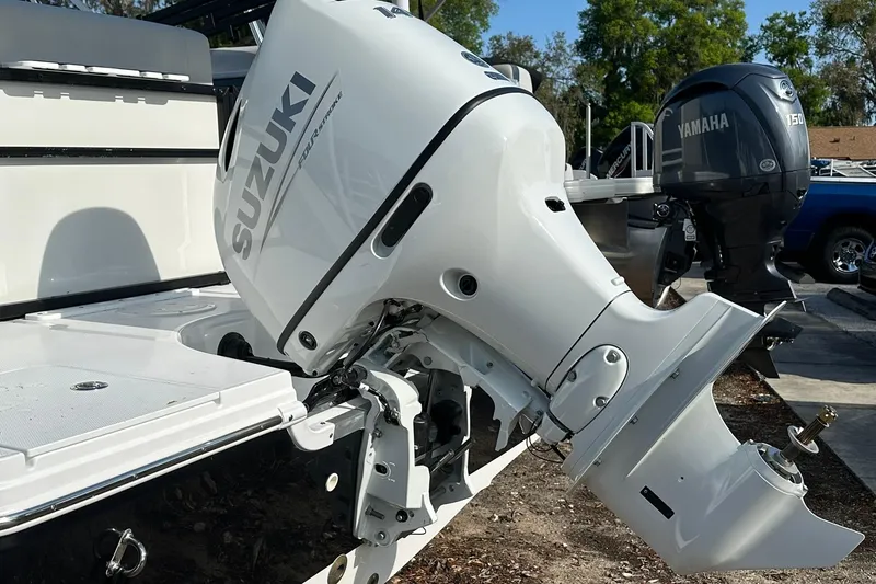 Slide: The Image of 2026 Hurricane FunDeck 1960 REF OB with Suzuki outboard motor in a marina setting. - 38